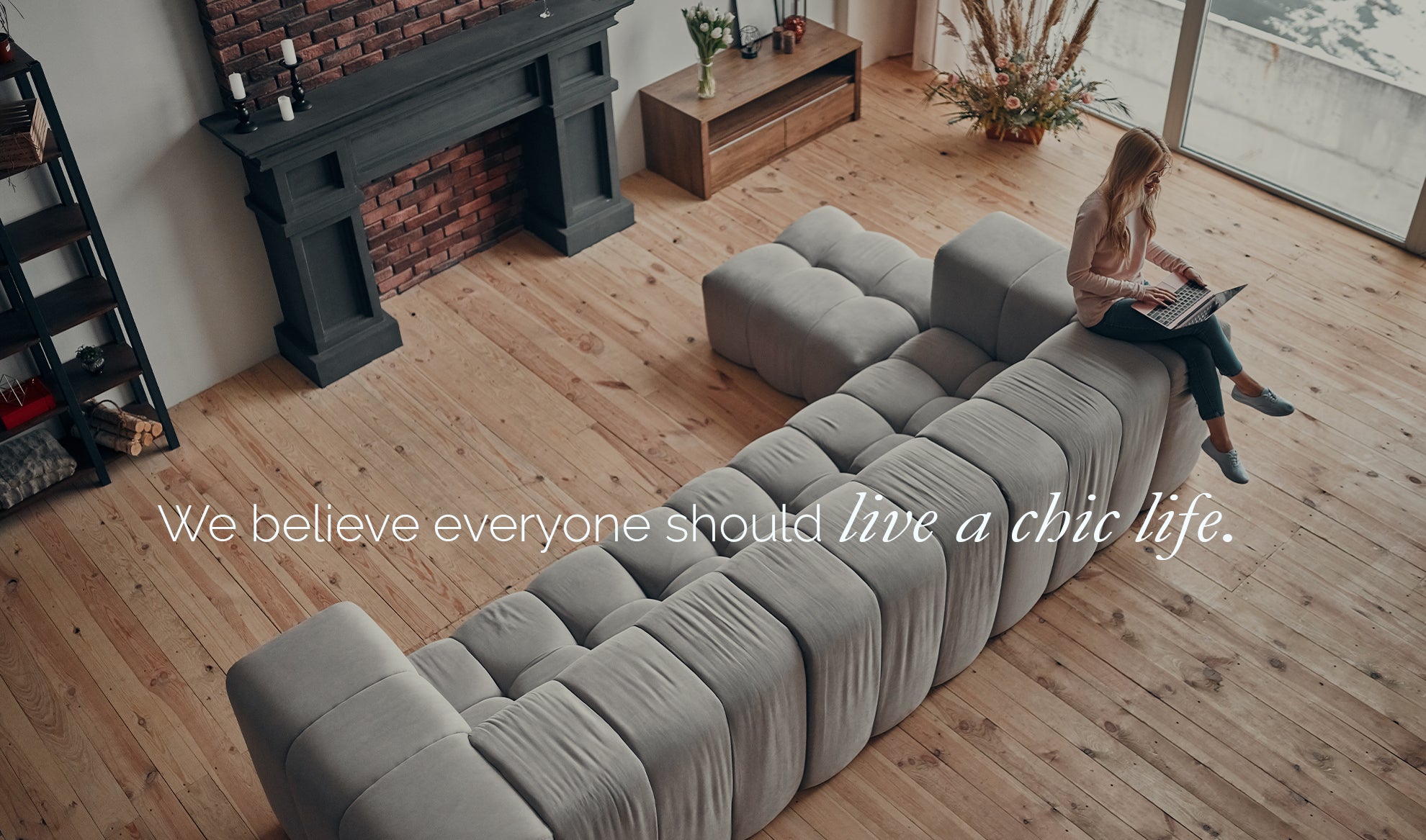 woman sitting on the back of a couch with a laptop