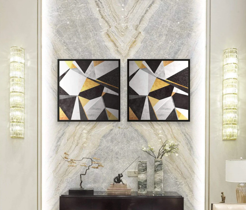 Black white and gold paintings on a marble wall